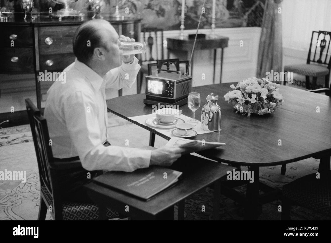 Präsident Gerald Ford essen Frühstück im Weißen Haus, Feb 6, 1975. Seine 4 x 5" tragbarer Fernseher war der letzte Schrei. (BSLOC 2015 14 55) Stockfoto