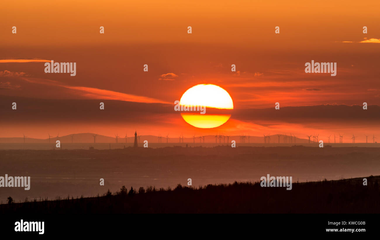 Sonnenuntergang über der Insel des Mannes mit einem weit entfernten Blackpool im Vordergrund. Stockfoto