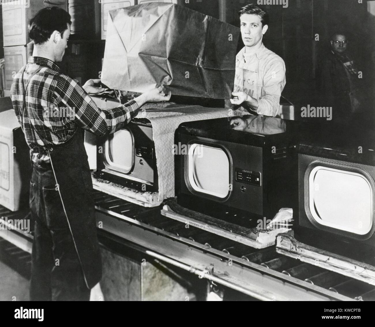 Am Ende des Fließbandes sind geprüfte Fernseher in eine amerikanische Fabrik verpackt. Juli 1949. -(BSLOC 2014 17 138) Stockfoto