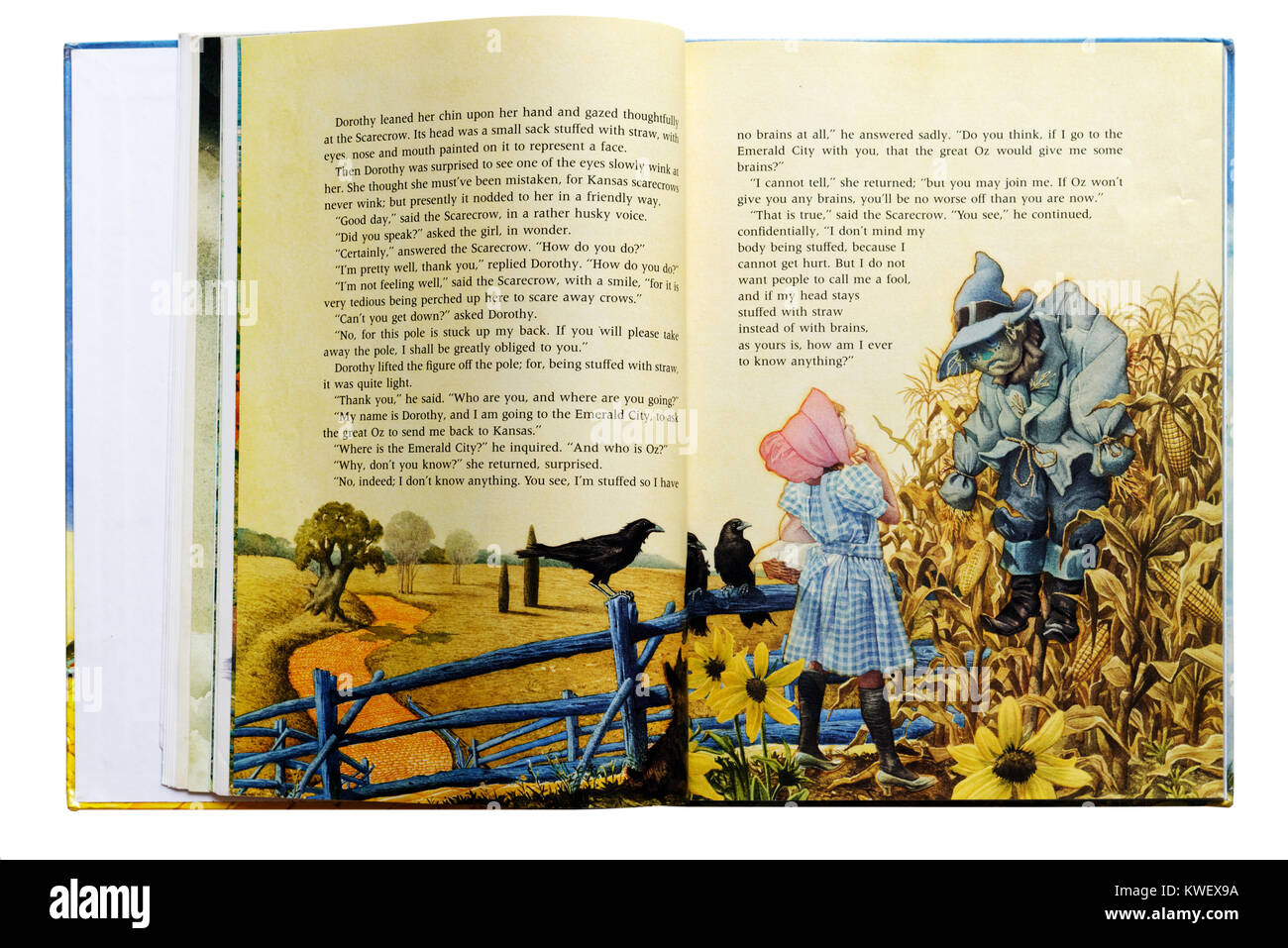 Dorothy erfüllt die Vogelscheuche in einem illustrierten Buch Der Zauberer von Oz Stockfoto