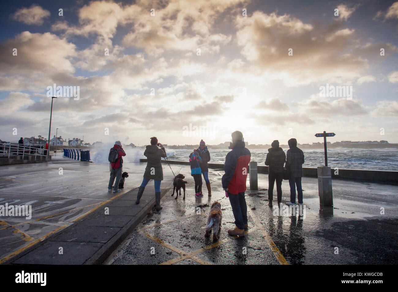 Anglesey, Wales, 3. Januar 2018. UK Wetter. Eine schwere Met Office Warnung hat für das fünfte Sturm der britischen Saison ausgestellt wurde Tropensturm Eleanor. Mit einem Anstieg der Gefahr durch die aktuelle Mond- und Gezeiten Hochwasserwarnungen für viele Bereiche zusammen mit gales Winde wahrscheinlich Schaden zu verursachen. Wellen und Wind Crash in Trearddur Bay auf Anglesey im Norden von Wales als Sturm Watchers Blick von der Brandung aus sicherer Distanz Stockfoto