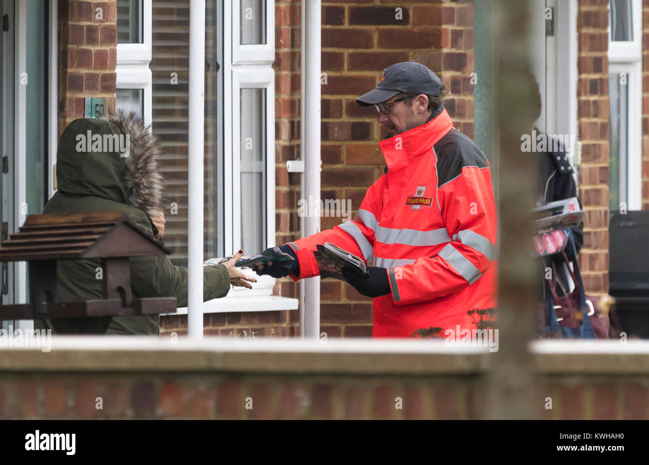 Royal Mail postbote vorbei an Post zu jemand in England, Großbritannien. Stockfoto