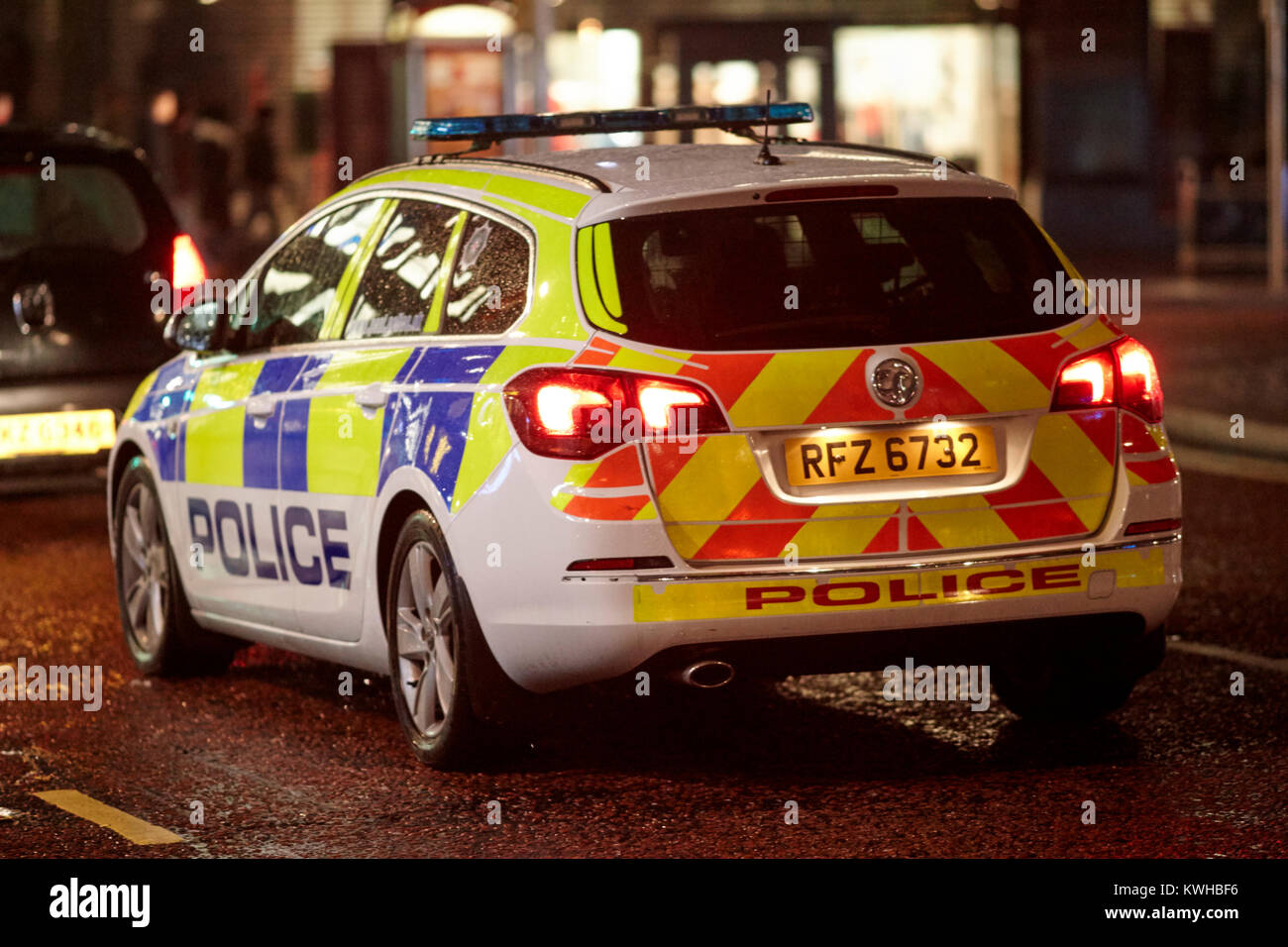 Polizei Fahrzeug nach Auto in der Nacht im Stadtzentrum Belfast Nordirland UK Stockfoto