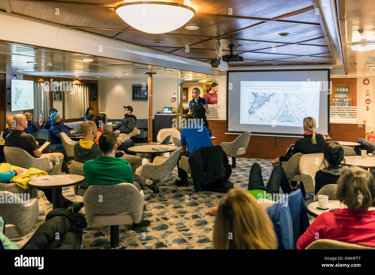 Quark Expeditions Moderatoren in der Lounge; Passagierschiff Ocean Abenteurer trägt alpinen Bergsteigen Skifahrer in die Antarktis Stockfoto