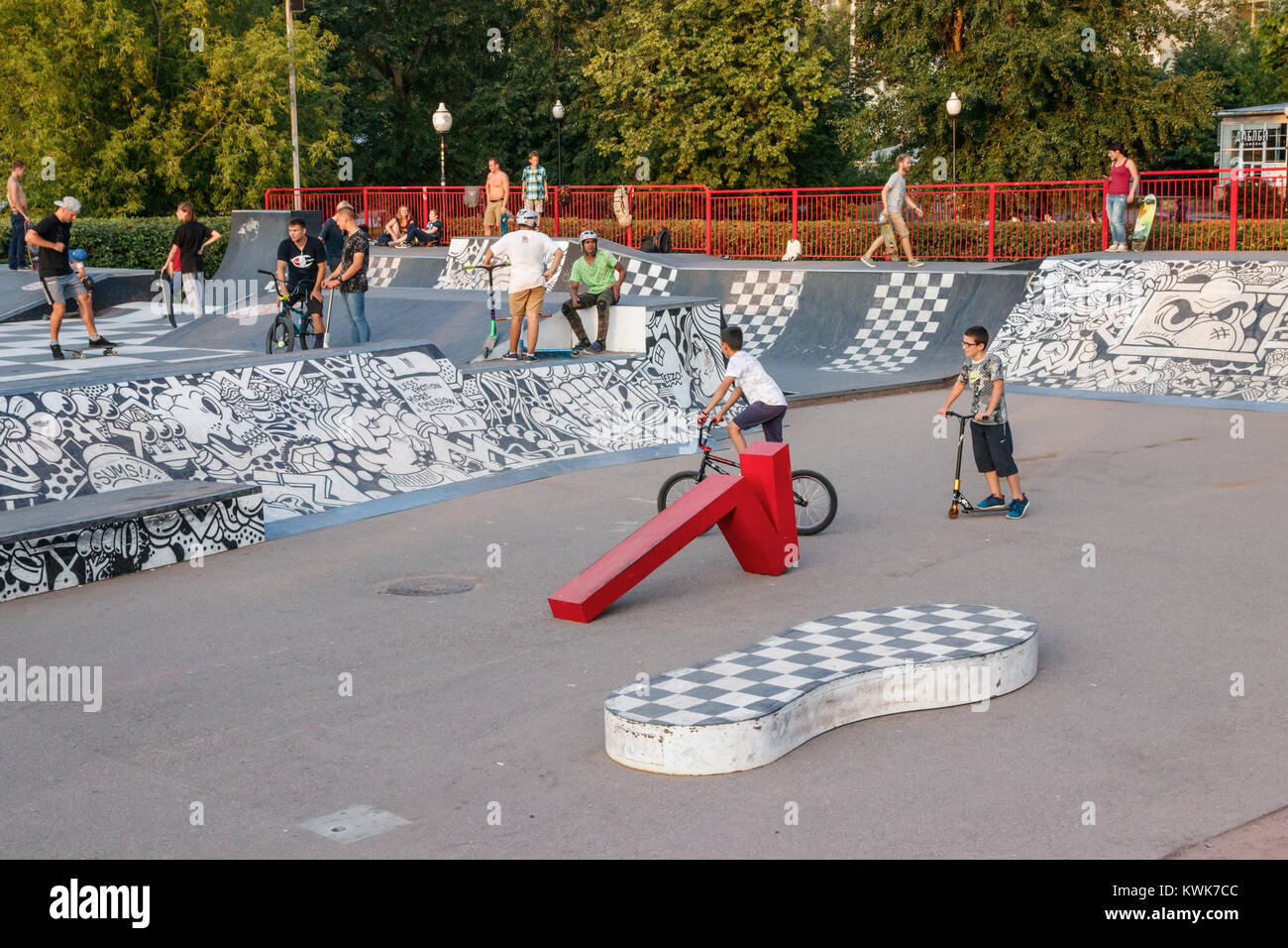 Lokale Jugend mit Fahrrädern, Skateboards und Kick-roller Am Skatepark, mit schwarzen und weißen Street Art in der Moskauer Gorky Park, Russland eingerichtet. Stockfoto