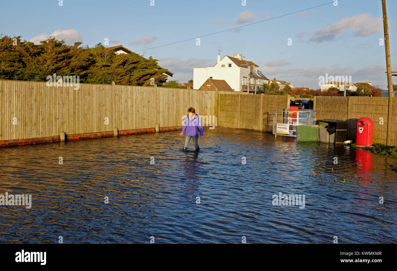 Worthing, Großbritannien. Am 4. Januar, 2018. Ein Walker versucht ihren Weg durch Hochwasser entlang Ferring direkt am Meer in der Nähe von Worthing nach dem Meer bei starkem Wind und Gezeiten Heute: Simon Dack/Alamy Leben Nachrichten gekommen war, zu machen, Stockfoto