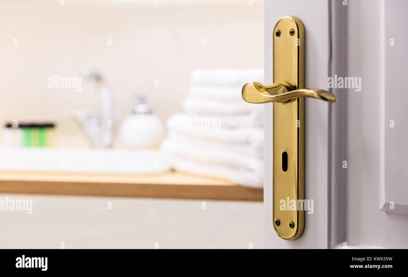 Badezimmer aus offenen Tür. Unscharfer Hintergrund, weiße Handtücher, Seife neben dem Waschbecken. Nahaufnahme, Details. Stockfoto