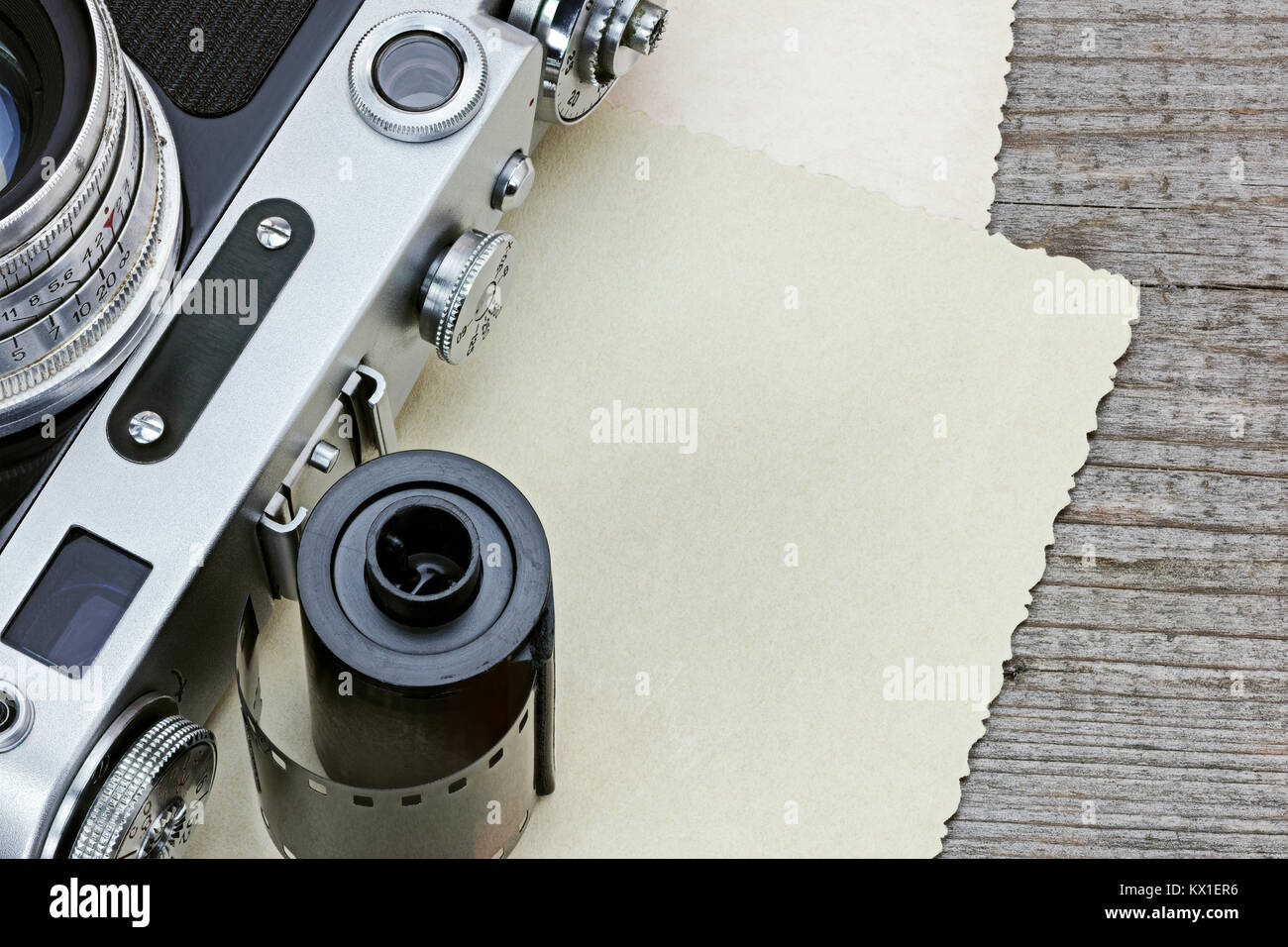 Alte Kamera, Film Roll und alte Bilder auf grau Holztisch Detailansicht Stockfoto