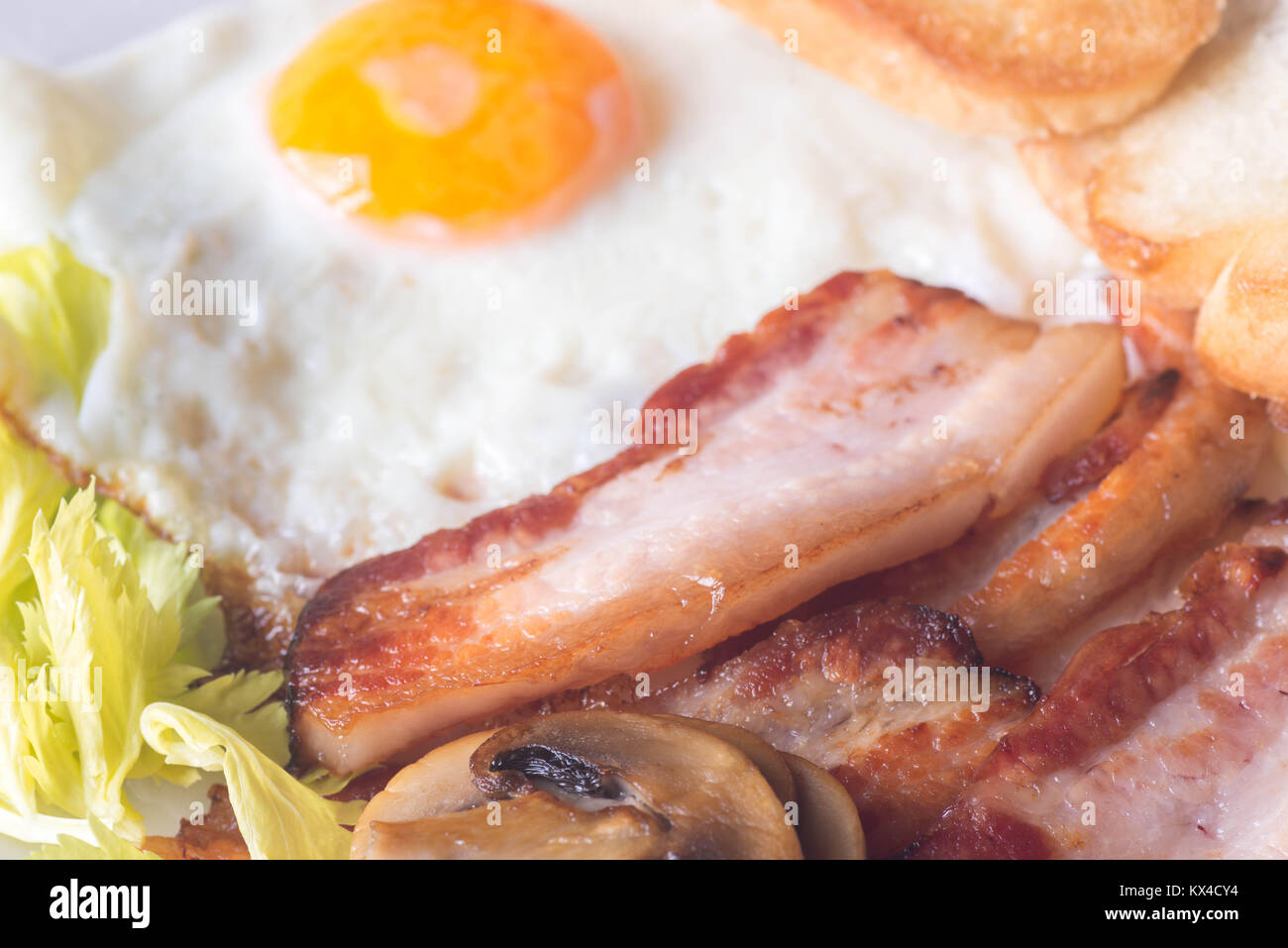 Spiegelei, Speck, Toast und Pilz für Frühstück auf Platte Stockfoto