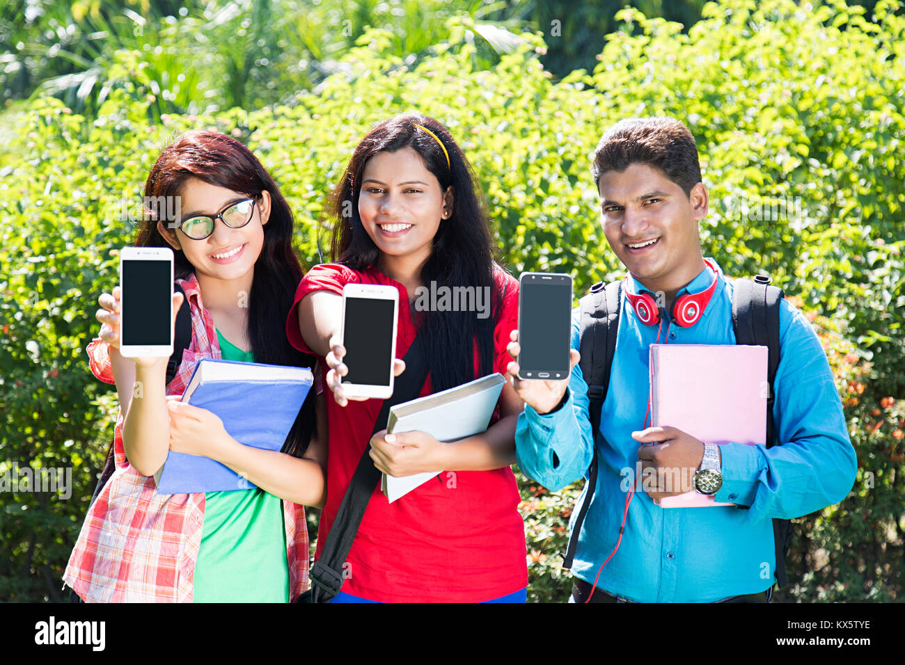 2 indische Studenten Freunde Lesen von Text Nachricht Telefon Park Stockfoto