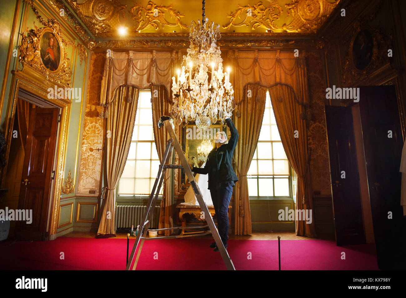 Woodstock, Oxfordshire, UK. 08 Jan, 2018. Palace Reiniger ihre jährliche säubern tief im Winston Churchill's Kindheit home Dirigieren, Blenheim Palace. Palace Cleaner Alison Darke reinigen und Kronleuchter aus vergoldeter Bronze (LouisXV, ca. 1740) Im ersten Immobilien Zimmer. Bild von Richard Höhle 08.01.18 Credit: Richard Höhle/Alamy leben Nachrichten Stockfoto