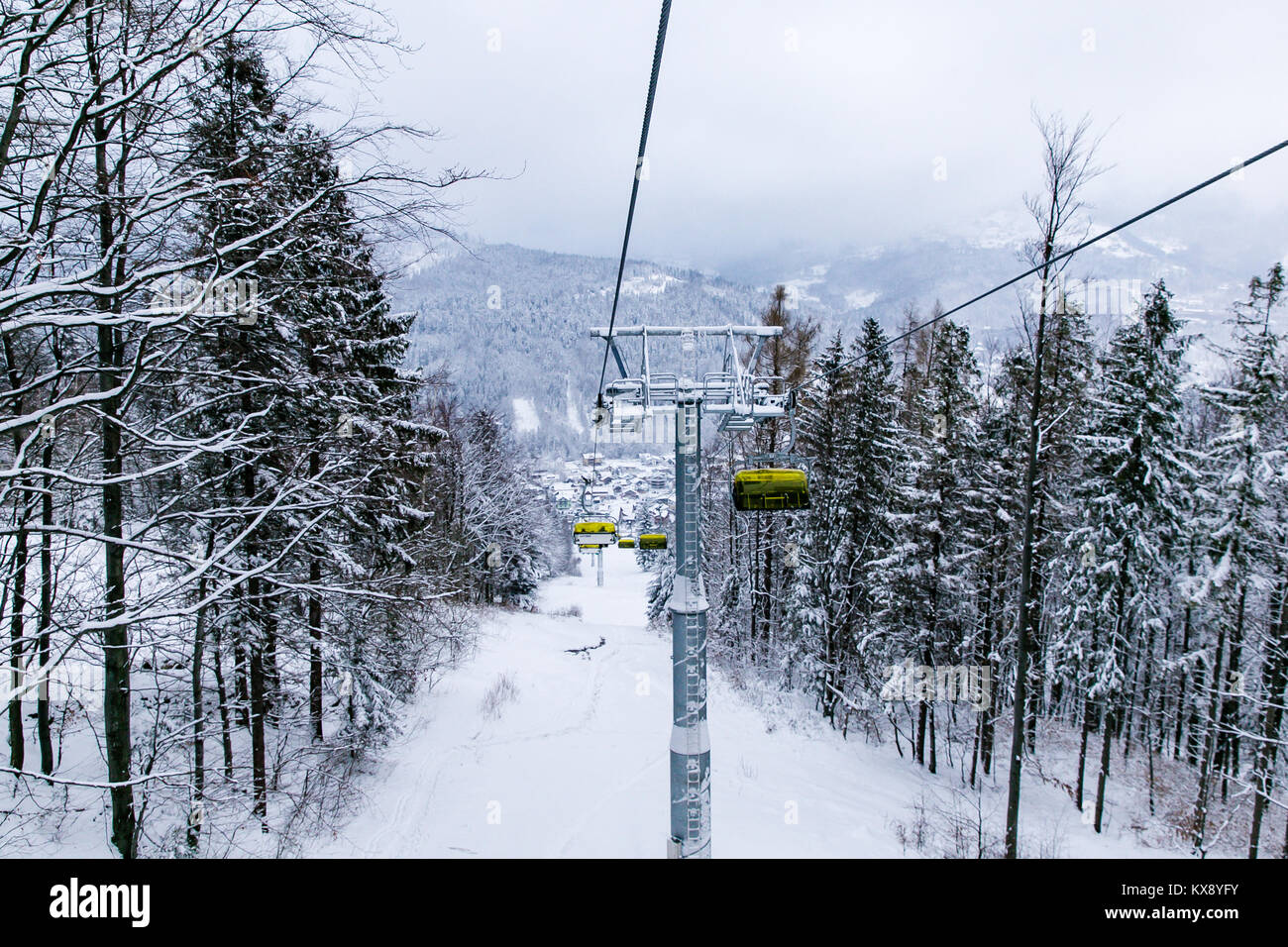 Ski Sessellift bringt Skifahrer und Snowboarder auf den Berg Skrzyczne nach starker Schneefall auf einem nebligen Wintertag in Szczyrk ski resort in Polen Stockfoto