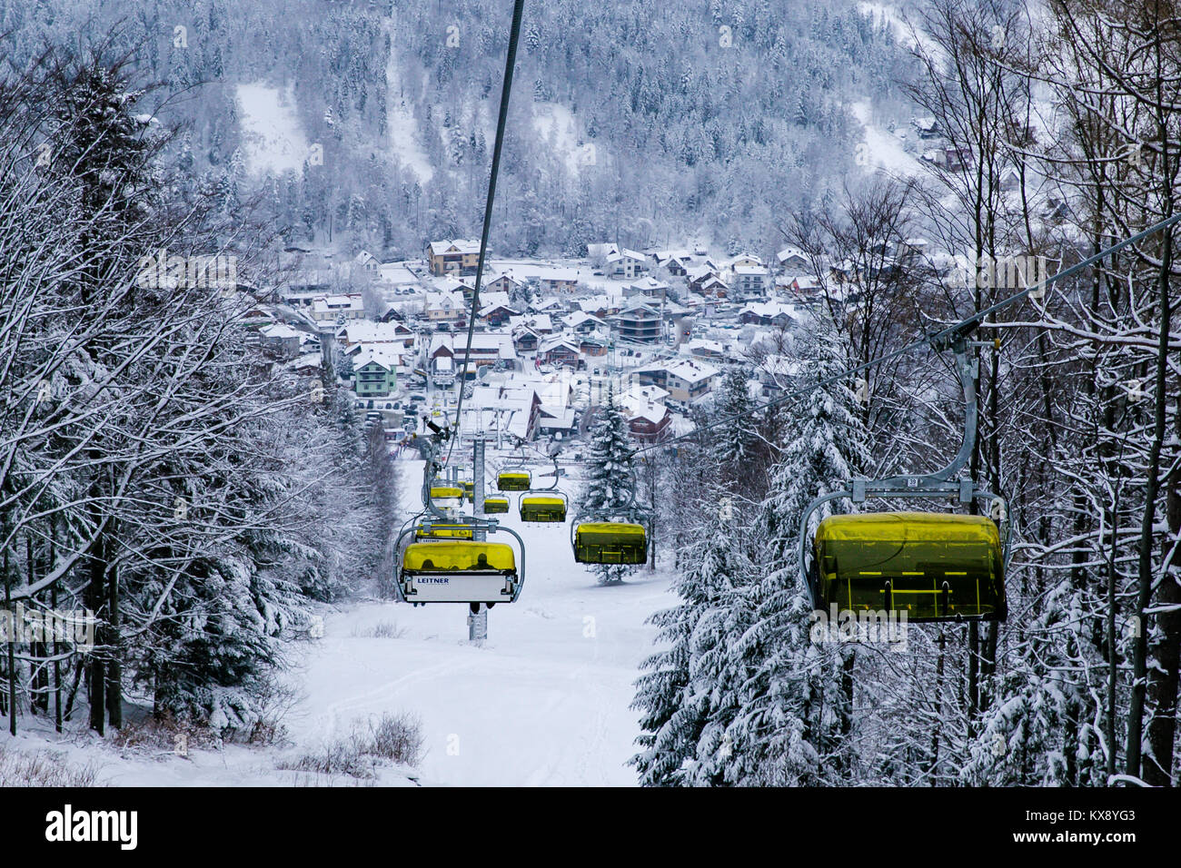 Ski Sessellift bringt Skifahrer und Snowboarder auf den Berg Skrzyczne nach starker Schneefall auf einem nebligen Wintertag in Szczyrk ski resort in Polen Stockfoto