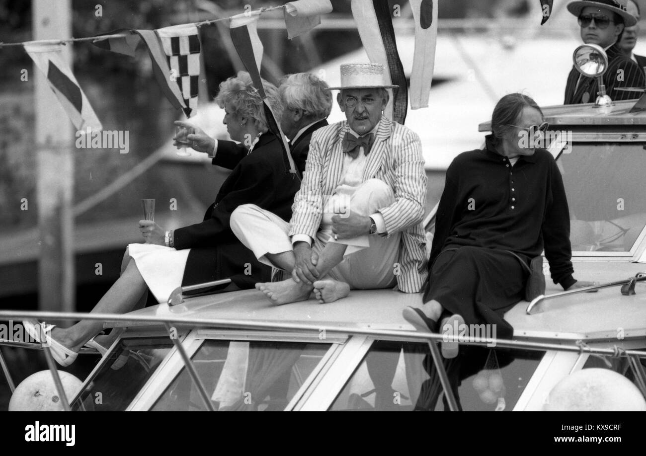 Juli 1990, Henley on Thames, Oxfordshire, England. Henley Royal Regatta Szene auf der Themse. Eine monacled Mann sportliche Blazer und Bootsfahrer an Bord ein Motorboot Foto von Tony Henshaw Stockfoto