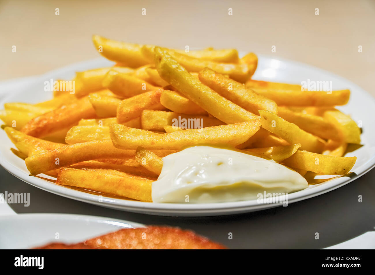 Gießen Käse Soße auf Pommes Frites, Nahaufnahme. Stockfoto