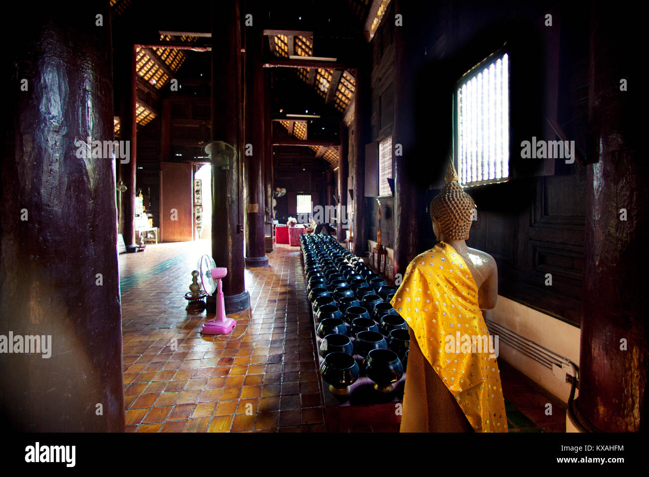 Ein Mönch ist das Studium in einem alten Tempel der Wat Phan Tao genannt. Dies ist einer der älteren Tempel von Chiang Mai fand im historischen Zentrum der Stadt. Alle dieser alten Tempel ist aus Teakholz. Chiang Mai, Thailand Stockfoto