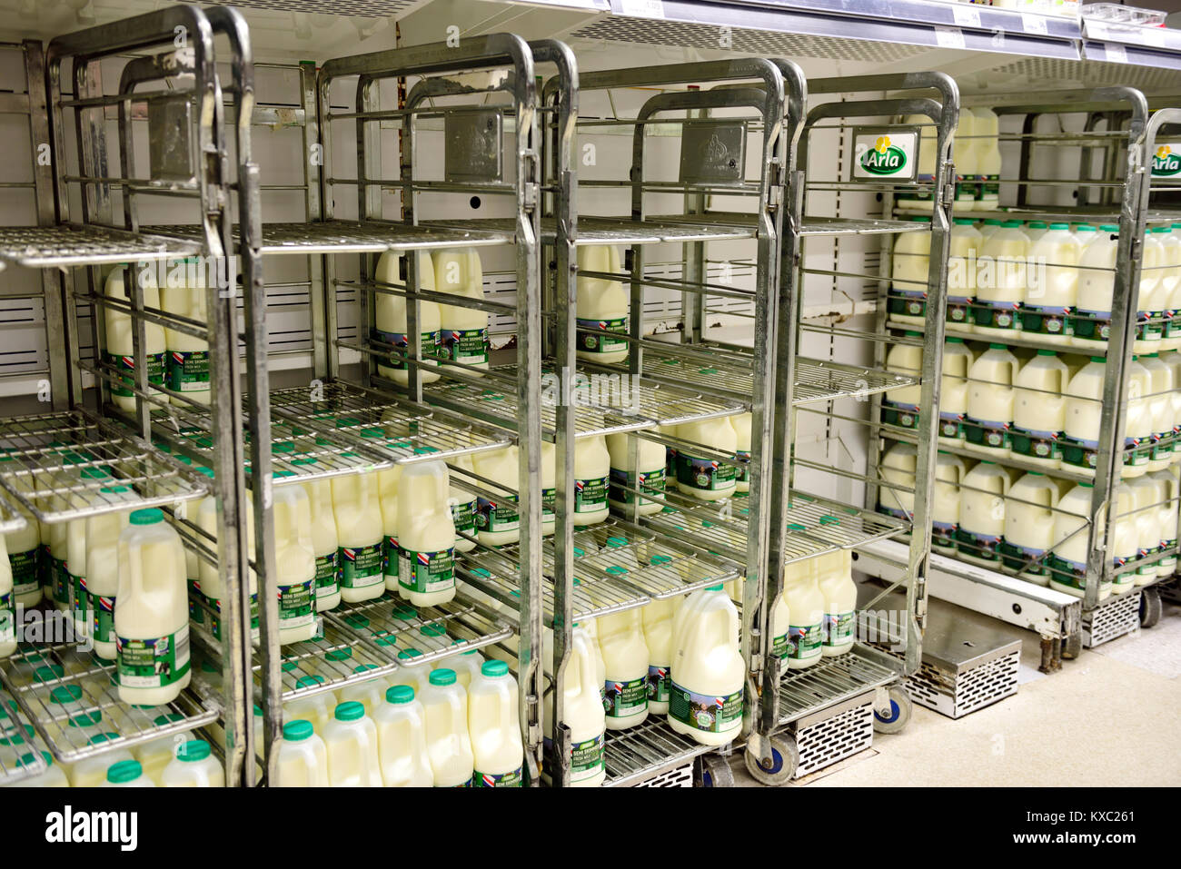 Anzeige von vier und sechs pint Kunststoff Kartons von Milch auf gekühlte Kabel Regalsysteme für effiziente Disposition in Supermarkt. Stockfoto