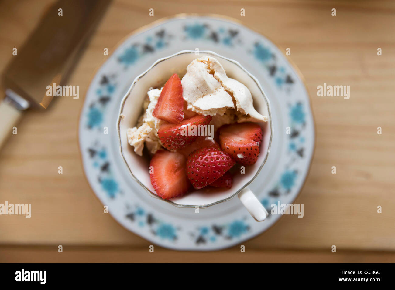 Frische Erdbeeren und Baiser Wüste serviert in einem Vintage Tee Tasse Stockfoto