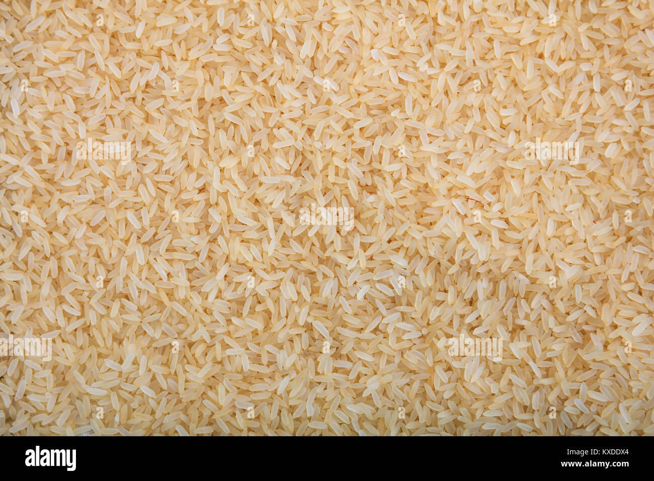 Parboiled Reis als Hintergrund Stockfoto