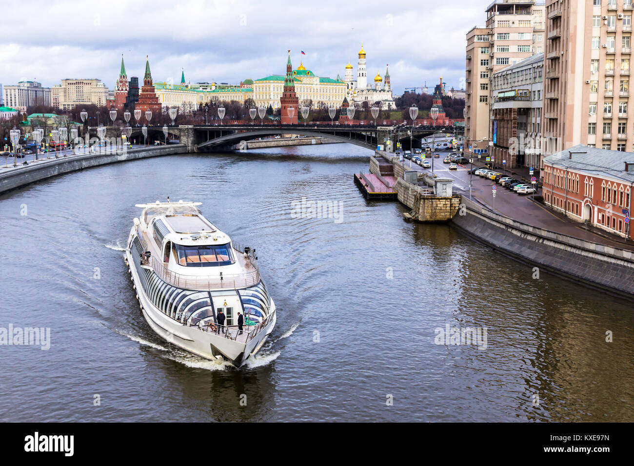 Blick auf den Kreml von der patriarchalischen Brücke. Ein tauwetter in der Mitte des Winters. Eine sightseeing Schiff auf nicht gefrorenen Fluss Moskwa im Vordergrund. Stockfoto