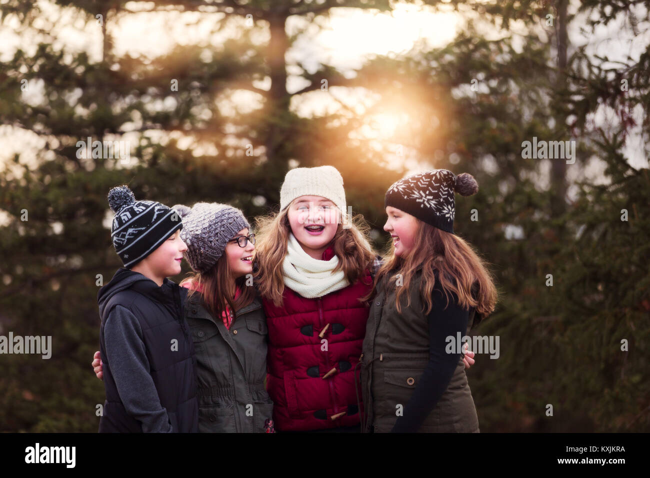 Jungen und drei weibliche Cousins mit Arme um einander im Garten Stockfoto