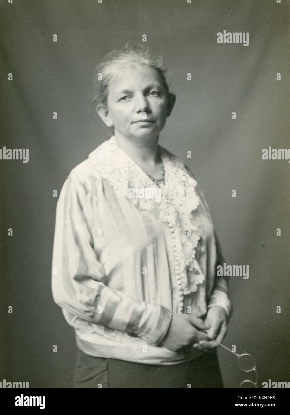 Porträt von Ida Benczúr mit Gesichtszügen, Haaren und Kleidung, die vor einem neutralen Hintergrund dargestellt wird. Stockfoto