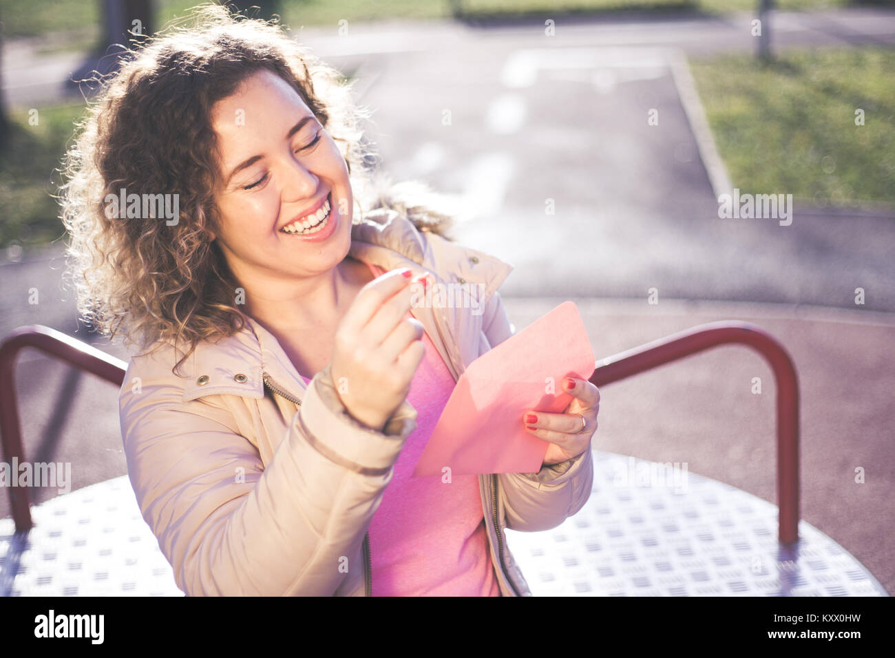 Junge schöne Frau eine Herzform Gold Halskette Geschenk von ihrem Freund und lächelnd am Valentines Tag. Stockfoto