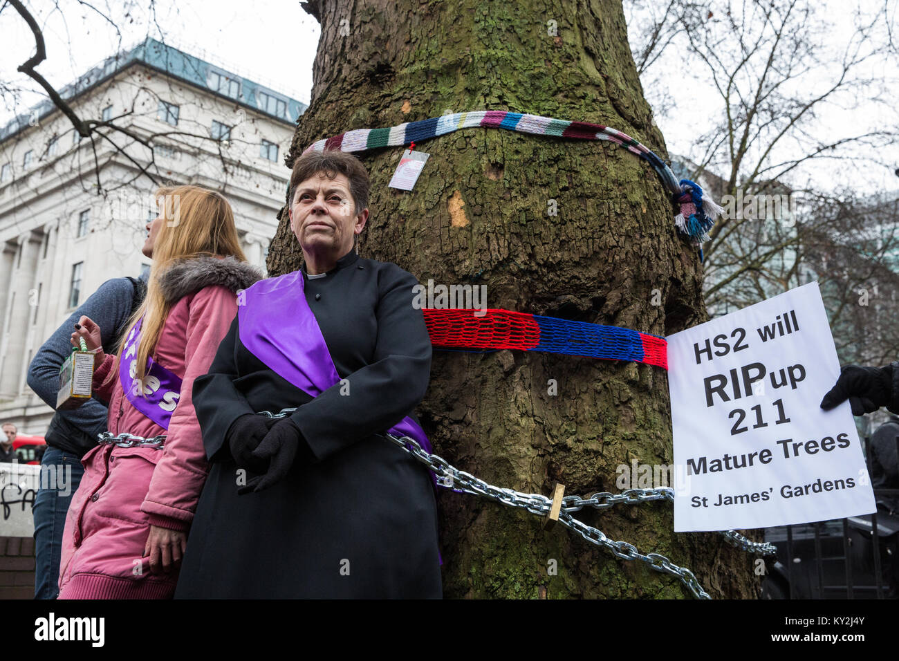 London, Großbritannien. Januar 2018. Anne Stevens, der Vikar der St. Pancras Kirche, wird an einen Baum mit Jo Hurford außerhalb Euston Station als Teil einer Kampagne von Anwohnern aus Protest gegen den geplanten Abschlag von reifen London Flugzeug, Red Oak, Common Lime, Gemeinsame Weißbeam- und Wilddienstbäume in den Euston Square Gardens, um im Rahmen der Vorbereitungen für die HS2-Bahnstrecke temporäre Baustellen und einen verdrängten Taxistand freizumachen. Kredit: Mark Kerrison/Alamy Live Nachrichten Stockfoto