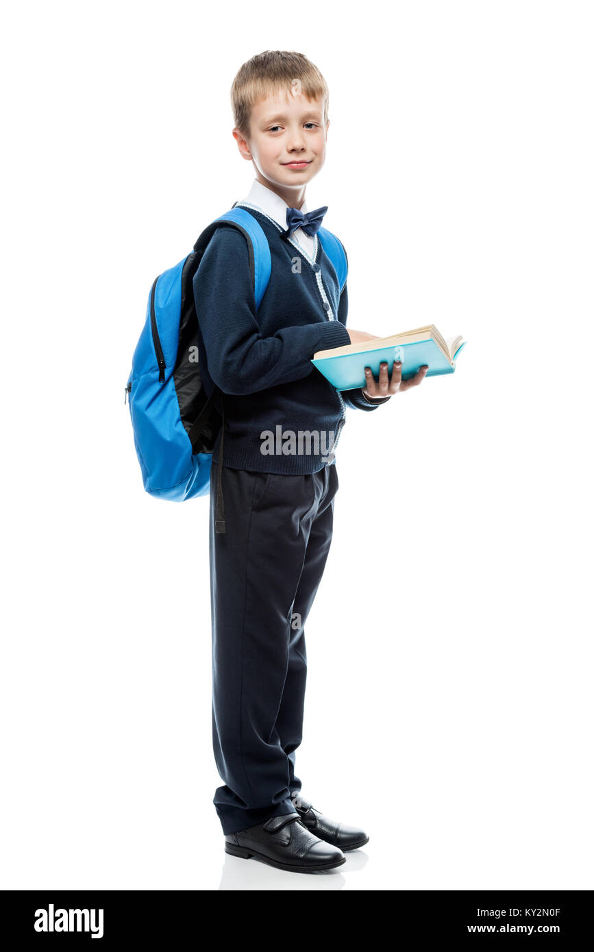 Schüler mit einem Buch und einem Rucksack in der Studio auf einem weißen Hintergrund in voller Länge isoliert Stockfoto