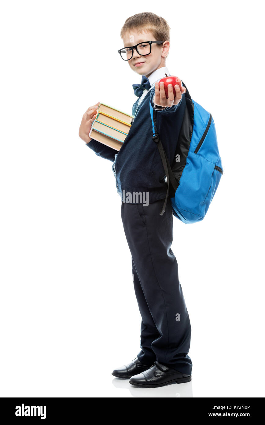Porträt eines Schülers in voller Länge auf einem weißen Hintergrund, in den Händen von Lehrbüchern und ein Apple Stockfoto