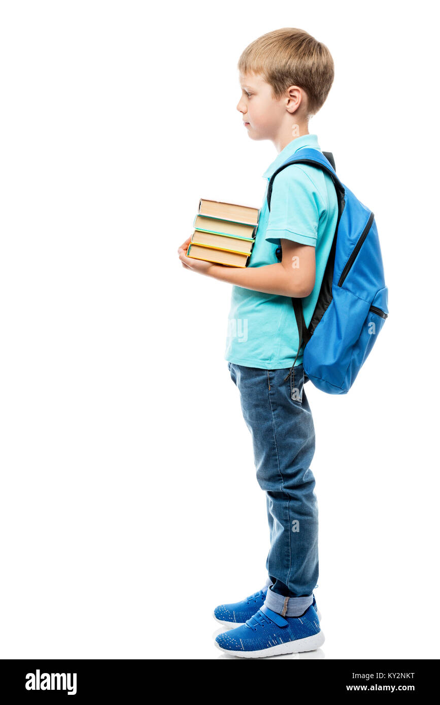 Schüler mit einem Bündel Bücher und einen Rucksack auf weißem Hintergrund in voller Länge Seitenansicht Stockfoto