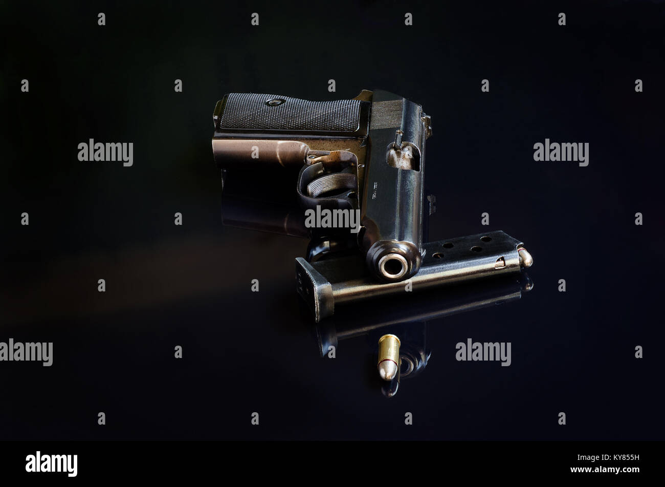 Pistole, Ladegerät und Bullet auf Schwarz reflektierenden Hintergrund Stockfoto