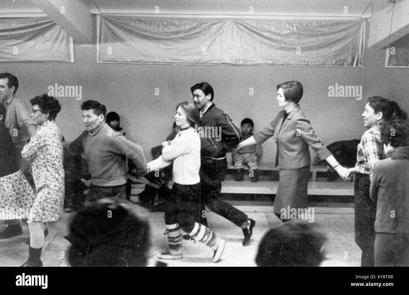 Ein Foto von Terry, Peter Pitseolak, Pat, Kananginak, Elli, und Tommy bei einem Freitagabend-Tanz, der ein kulturelles Ereignis in einer indigenen Gemeinde illustriert. Stockfoto