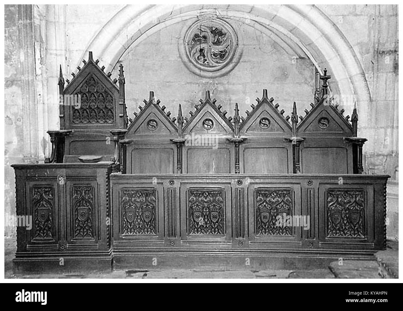 Die Chorstände der Kirche Saint-Eloi in Bordeaux, Frankreich, sind hölzerne Kirchenmöbel, die handwerkliches Können und gotische architektonische Details zeigen. Stockfoto
