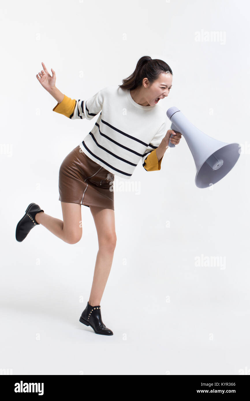 Junge Frau schreiend über Megaphon Stockfoto