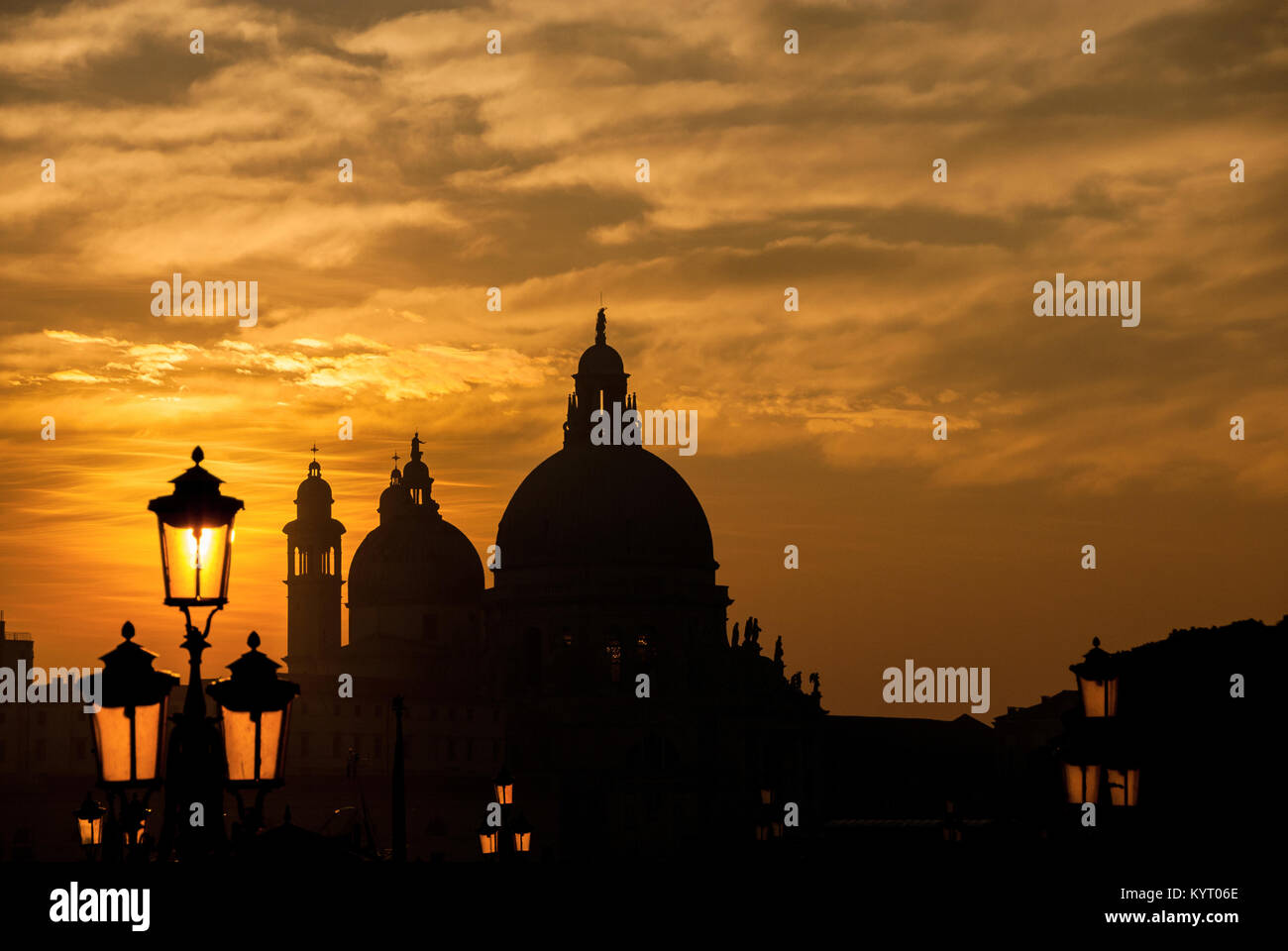 Venedig Sonnenuntergang mit Salute Basilika (Saint Mary für Gesundheit) barocken Kuppeln und Lampen Stockfoto