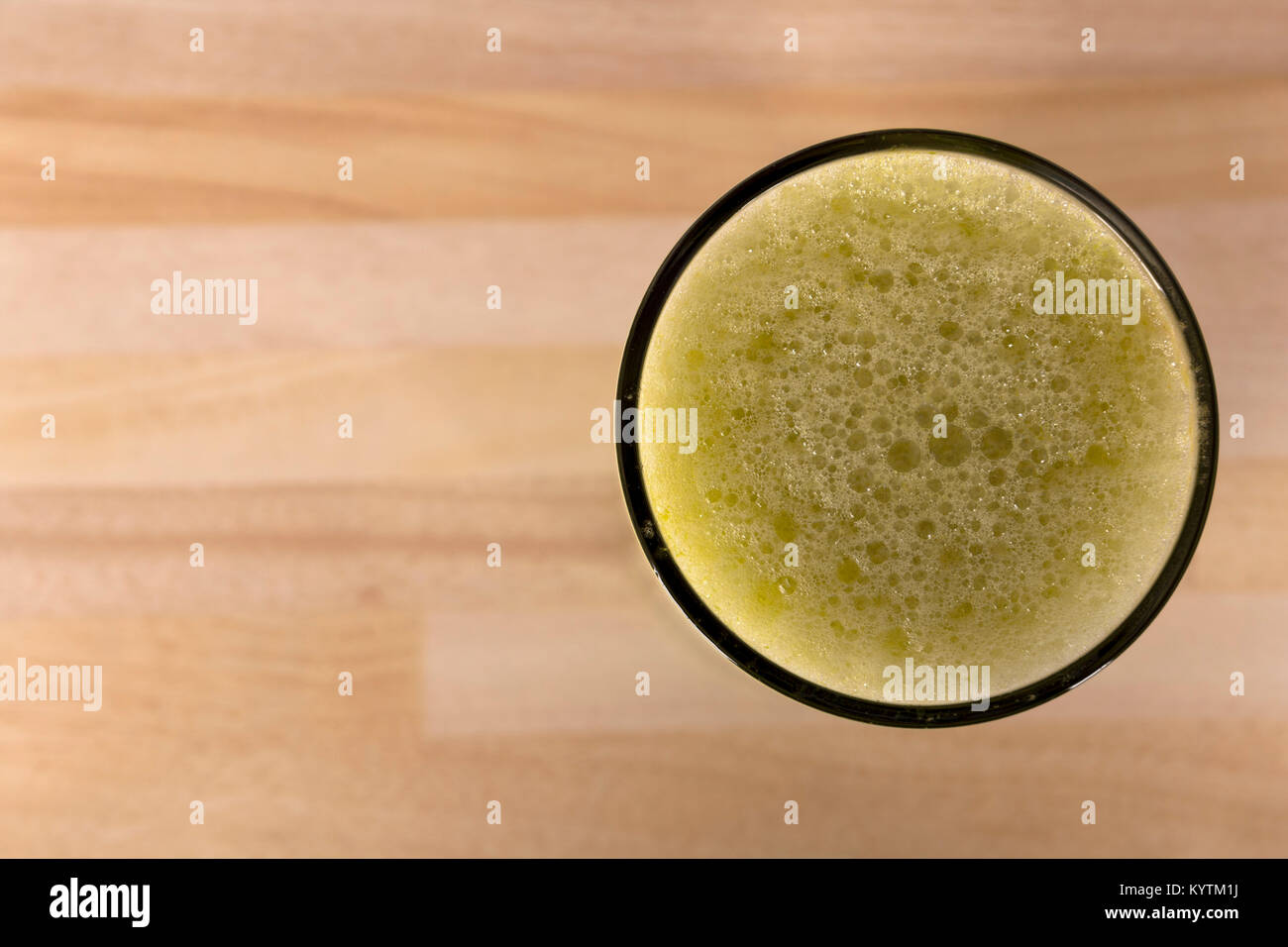 Mit Blick auf einen grünen Früchte und Gemüse in einem Glas auf einer Küche aus Holz Zähler nach oben Smoothie. Stockfoto