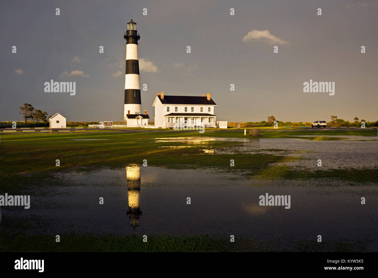 NC-01300-00... NORTH CAROLINA- die Sonne am späten Nachmittag nach einem sehr nassen Tag an Bodie Island Lighthouse in einer Pfütze widerspiegelt; Teil C Stockfoto