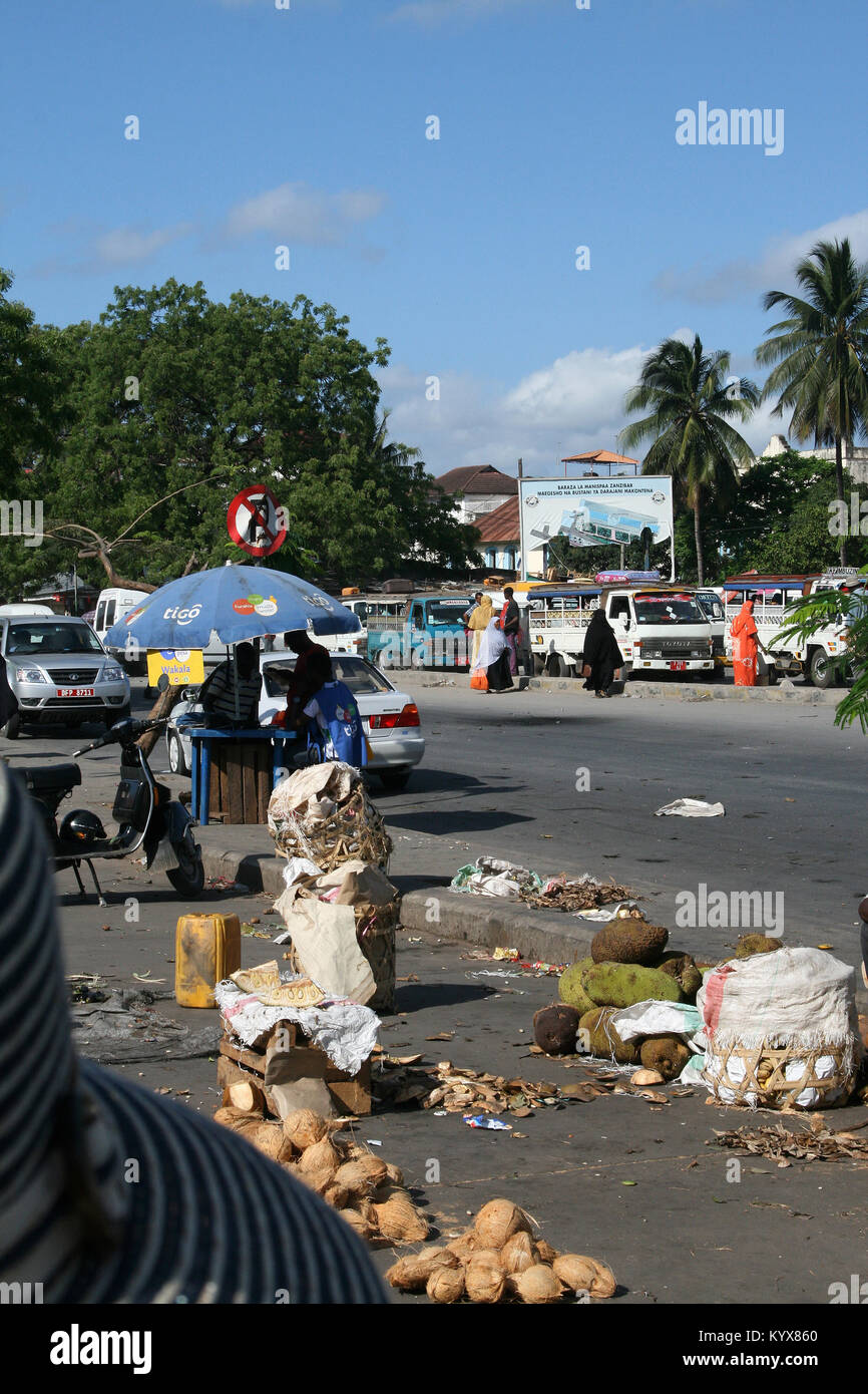 Müll auf dem Bürgersteig einer Straße voller Autos, Stone Town, Sansibar, Tansania. Stockfoto