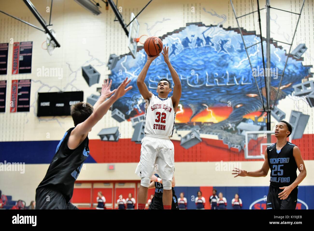 Spieler die Freigabe zum Jump über der Oberseite des Schlüssels und über die Verteidigung bei einem High School Basketball Spiel. USA. Stockfoto