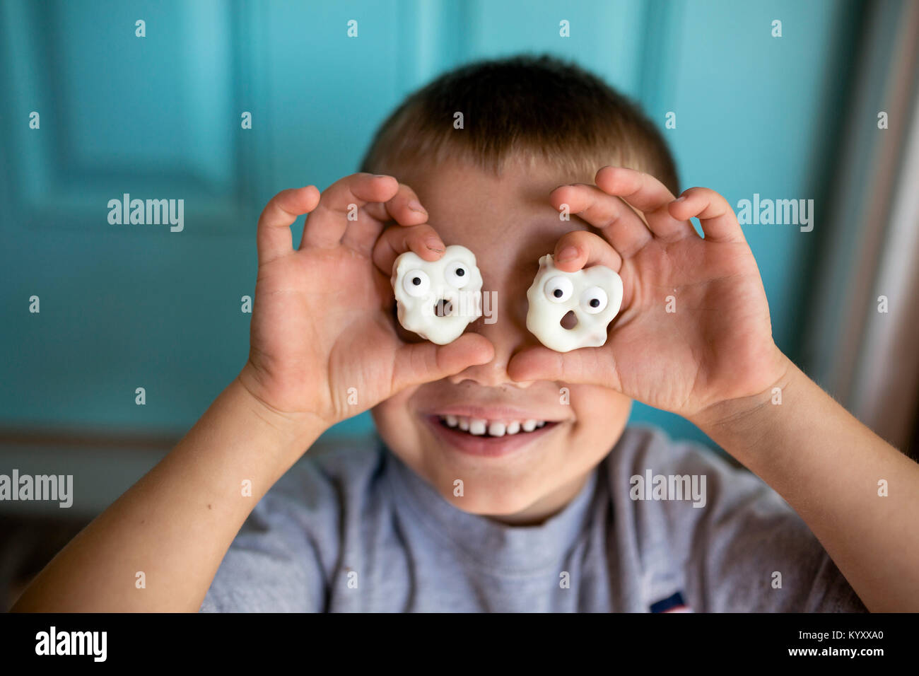 Close-up Happy Boy Holding anthropomorphen Cookies gegen Fläche Stockfoto
