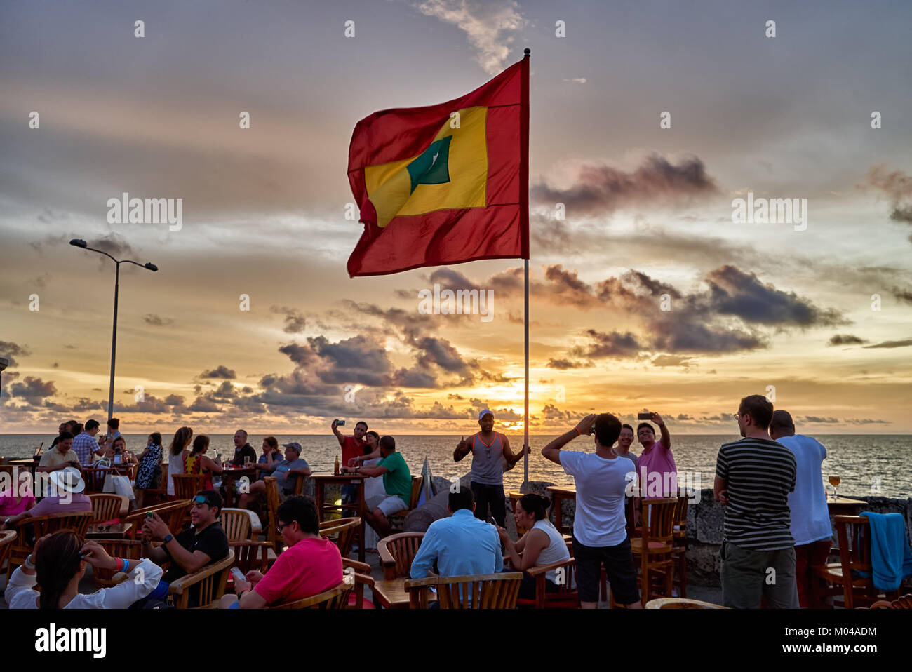 Wehende Flagge von Cartagena bei Sonnenuntergang am Cafe del Mar Stockfoto