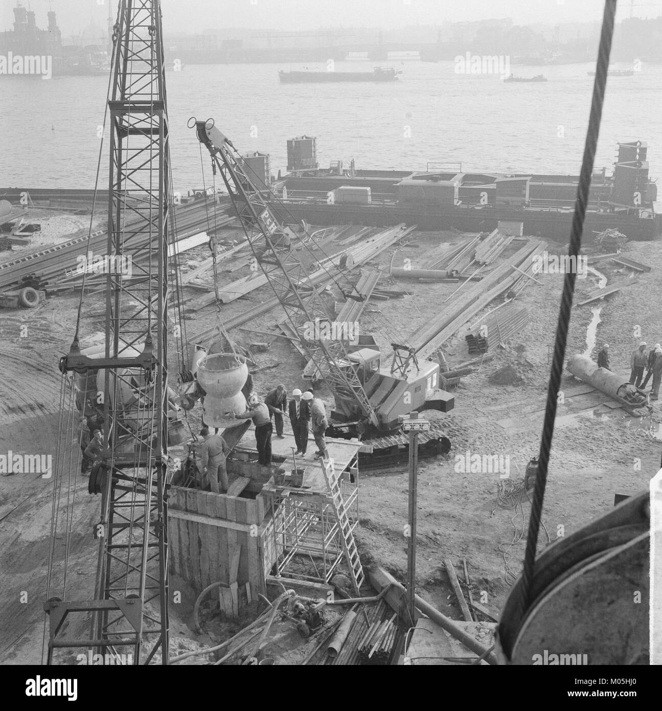 Dieses Bild zeigt die Anfangsphasen des Coentunnel, eines bedeutenden Infrastrukturprojekts in den Niederlanden. Der Tunnel, der den Verkehr in Amsterdam erleichtern sollte, wurde Mitte des 20. Jahrhunderts in Entwicklung gebracht. Stockfoto