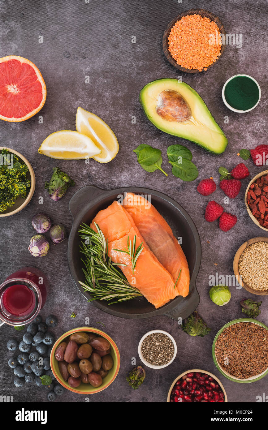 Fisch mit frische, gesunde Zutaten mit Samen, Hülsenfrüchte, Obst und Gemüse. Ansicht von oben, leeren Raum, rustikale Oberfläche Stockfoto