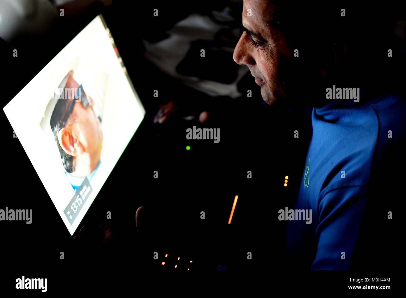 Grüner Bildschirm Bereit Android und mann Betrachtung gegen gestreifte Fenster von Schatten und Licht Muster Stockfoto