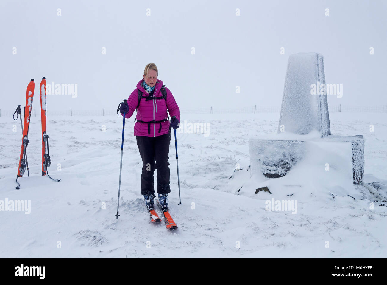 Skitourengeher auf dem Gipfel Trig von burnhope Sitz im Winter, Cumbria, Großbritannien Stockfoto
