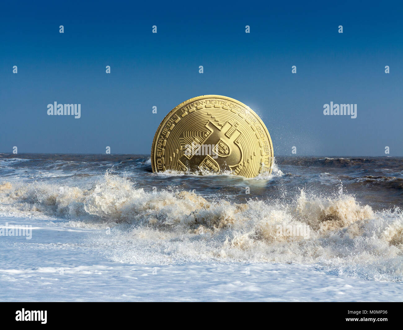 Eine schwimmende oder sinkende gold Bitcoin Token im Ozean mit Wellen auf den Strand Stockfoto