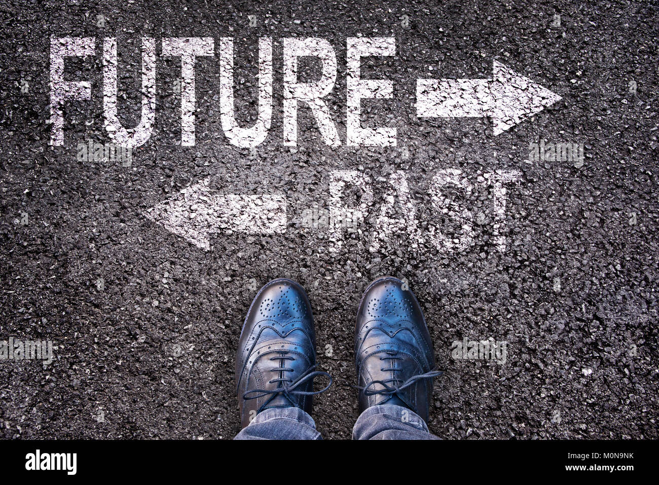Füße und Worte, die Zukunft und die Vergangenheit auf eine asphaltierte Straße lackiert Stockfoto