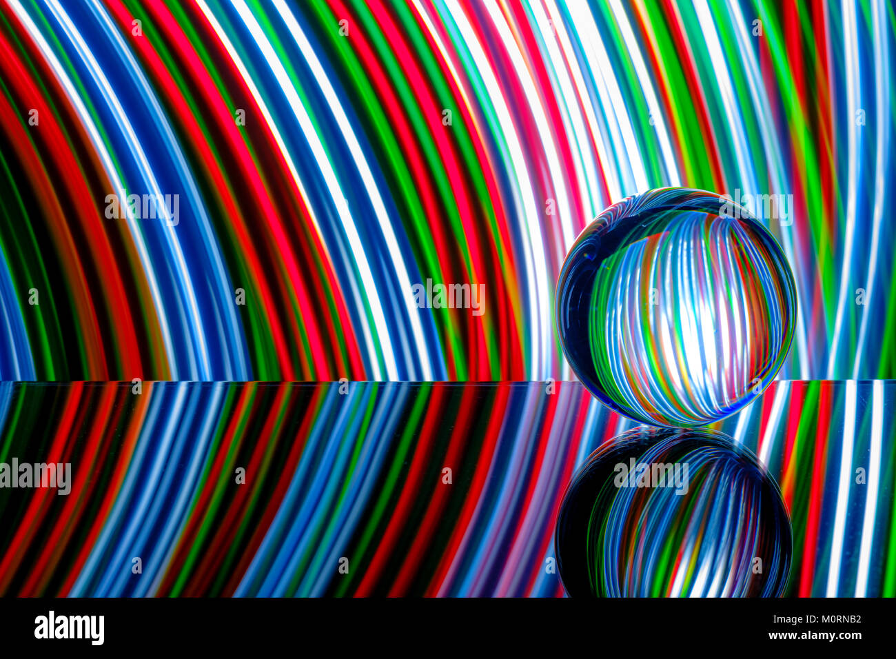 Glas/kristall Kugel reflektierende Licht streifen in Farbe Rot, Weiß, Blau und Grün. Stockfoto