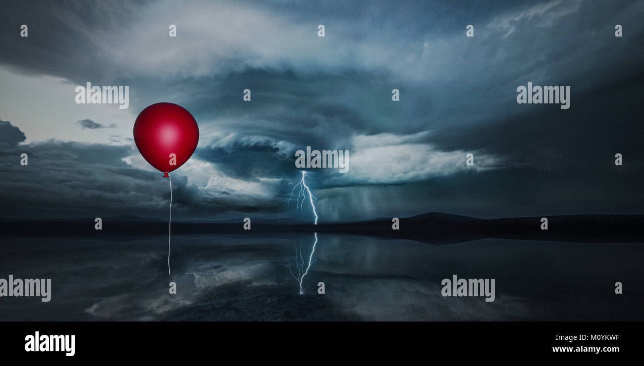 Red Ballon schweben in stürmischen Himmel Stockfoto